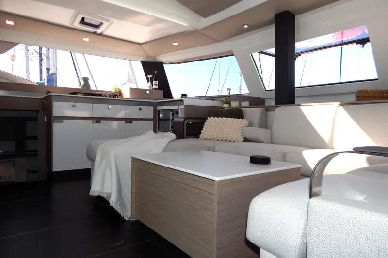  Yacht Photos Pics Luxurious interior of 2023 Fountaine Pajot Catamaran Elba 45 with modern furnishings and ample natural light.