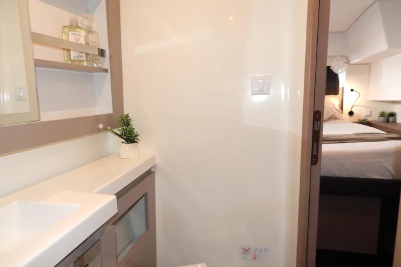  Yacht Photos Pics 2023 Fountaine Pajot Catamaran Elba 45 interior, featuring a modern bathroom and cozy bedroom.