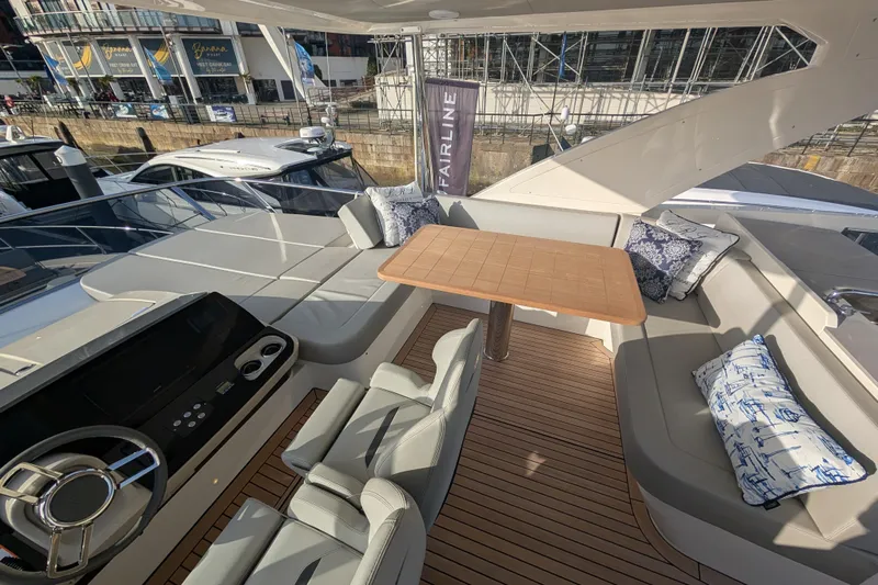  Yacht Photos Pics Luxurious 2025 Absolute 52 FLY yacht interior with elegant seating and modern helm.