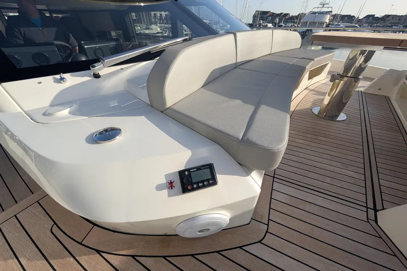  Yacht Photos Pics Luxurious seating on 2025 Absolute 52 FLY yacht with sleek design and wooden deck.