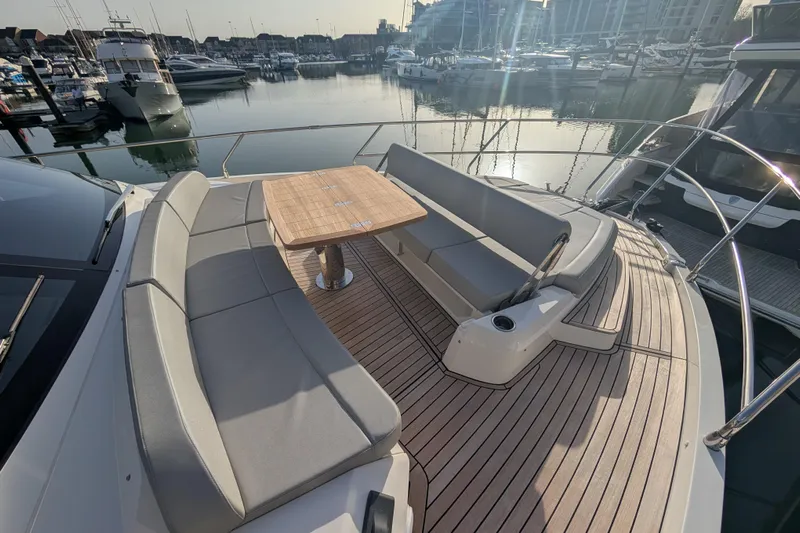  Yacht Photos Pics Luxury Absolute 52 FLY yacht deck with seating and table, docked in marina, 2025 model.