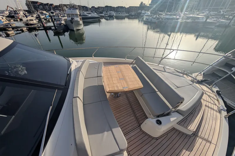  Yacht Photos Pics Luxurious 2025 Absolute 52 FLY yacht with elegant deck seating at marina.