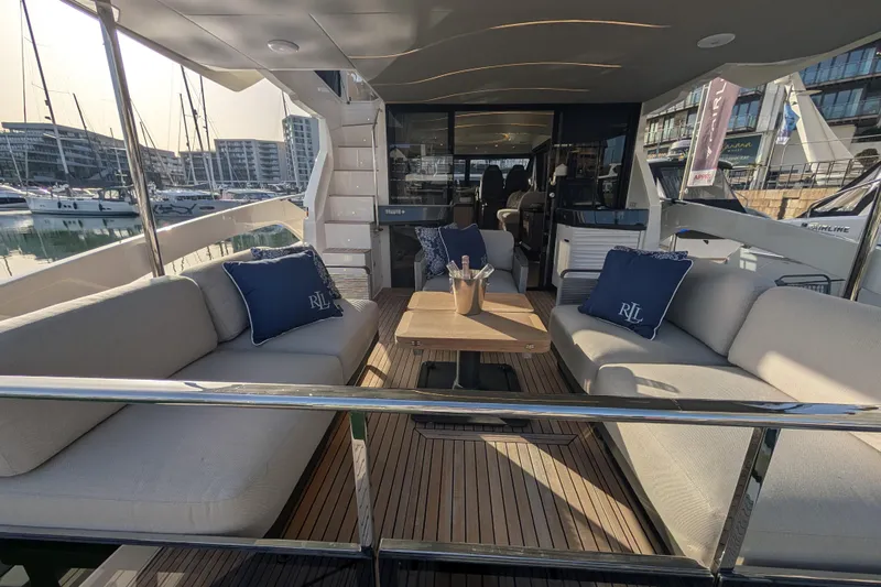  Yacht Photos Pics Luxurious 2025 Absolute 52 FLY yacht interior with elegant seating and marina view.