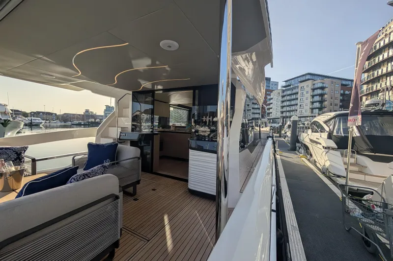  Yacht Photos Pics Luxurious 2025 Absolute 52 FLY yacht docked at a modern marina.