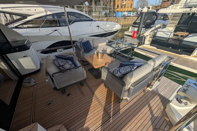  Yacht Photos Pics Luxurious deck of 2025 Absolute 52 FLY yacht with elegant seating and wooden flooring.