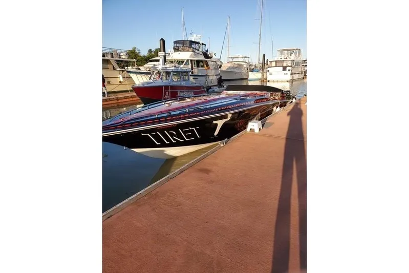  Yacht Photos Pics 2004 Fountain 42 Lightning speedboat docked at a marina, surrounded by other boats.