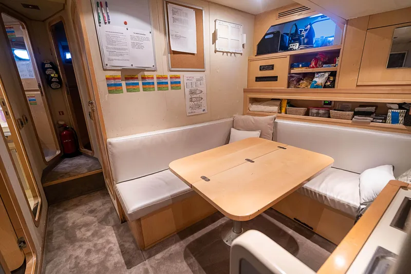 Patron Yacht Photos Pics Luxurious 2008 Ferretti Yachts Custom interior with cozy seating and elegant wooden table.