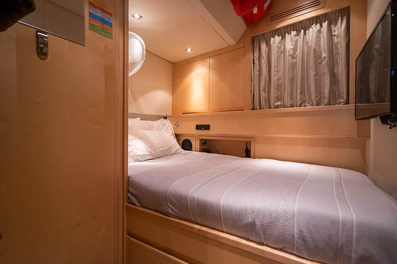 Patron Yacht Photos Pics Luxurious cabin interior of 2008 Ferretti Yachts Custom, featuring cozy bed and elegant wood finishes.