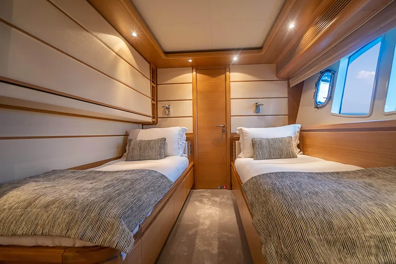 Patron Yacht Photos Pics Luxurious twin cabin on 2008 Ferretti Yachts Custom, featuring elegant wood paneling and soft lighting.