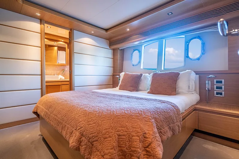 Patron Yacht Photos Pics Luxurious bedroom interior on a 2008 Ferretti Yachts Custom, featuring elegant wood finishes.
