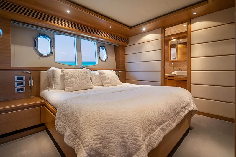 Patron Yacht Photos Pics Luxurious bedroom interior on 2008 Ferretti Yachts Custom, featuring elegant wood paneling and ocean view.