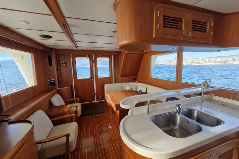 Mazu Yacht Photos Pics Luxurious 2011 Adagio 58 yacht interior with wooden finish and ocean view.