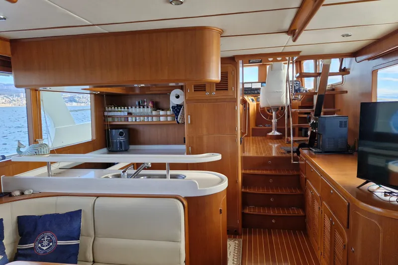 Mazu Yacht Photos Pics Interior of 2011 Adagio 58 yacht with wooden finishes and modern amenities.