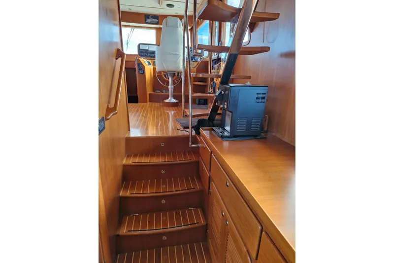 Mazu Yacht Photos Pics Interior of 2011 Adagio 58 yacht with wooden stairs and helm station.