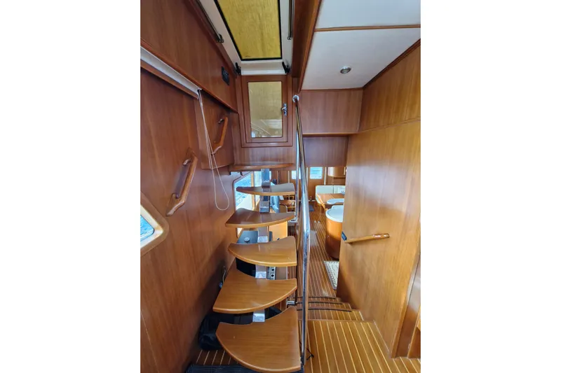 Mazu Yacht Photos Pics Interior of 2011 Adagio 58 yacht with wooden spiral staircase and modern design.