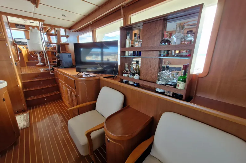 Mazu Yacht Photos Pics Luxurious Adagio 58 yacht interior with bar, TV, and seating, 2011 model.