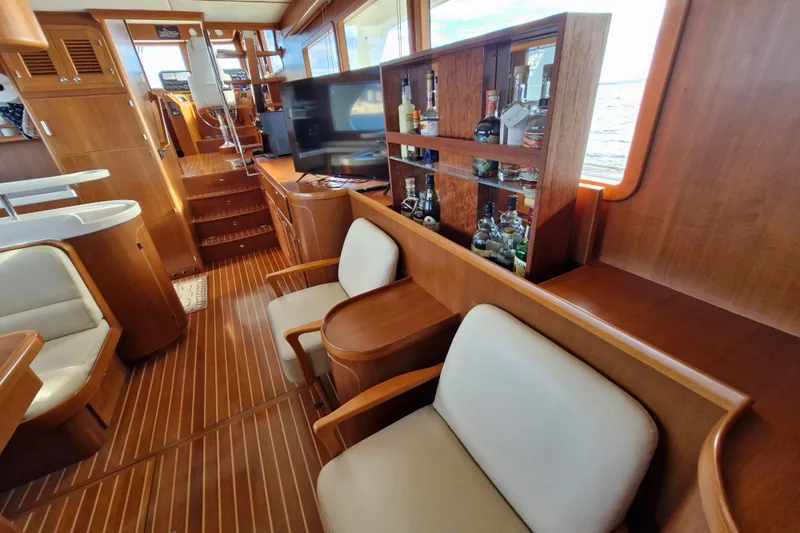 Mazu Yacht Photos Pics Luxurious Adagio 58 yacht interior with wooden finish, bar, and seating area, 2011 model.