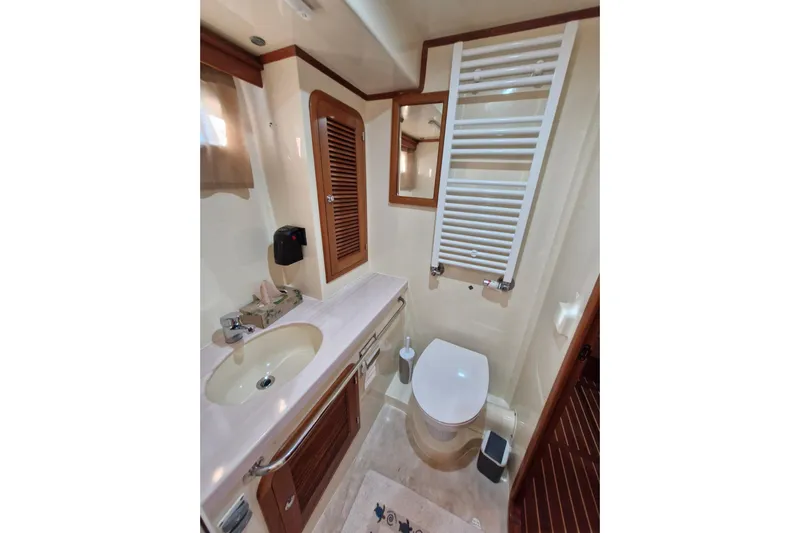Mazu Yacht Photos Pics Luxurious Adagio 58 yacht bathroom, featuring modern fixtures and elegant wood accents, 2011 model.