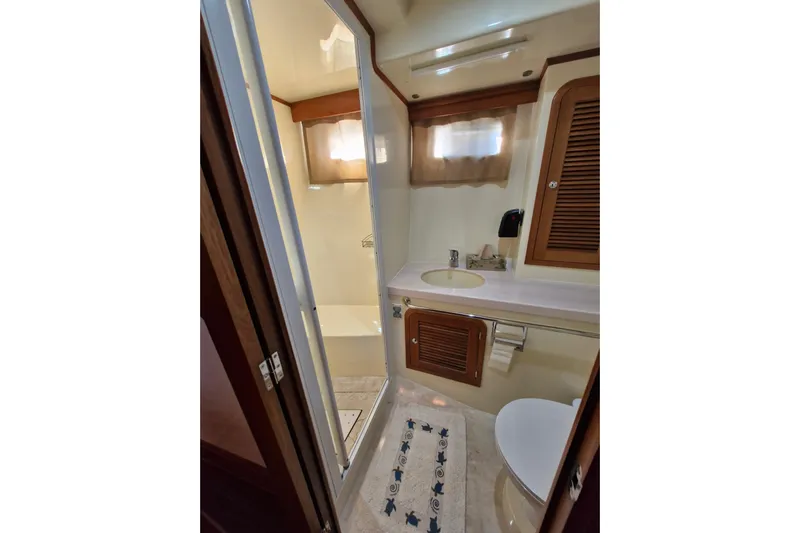 Mazu Yacht Photos Pics Luxurious Adagio 58 yacht bathroom, featuring shower, sink, and toilet, 2011 model.