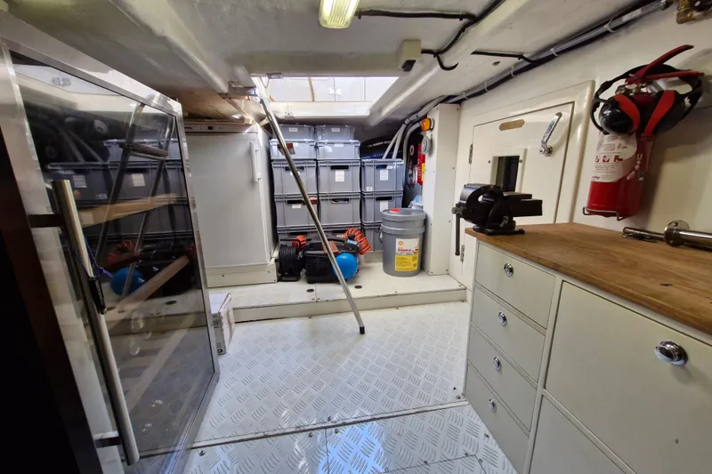 Mazu Yacht Photos Pics Engine room of 2011 Adagio 58 yacht with storage, tools, and fire extinguisher.