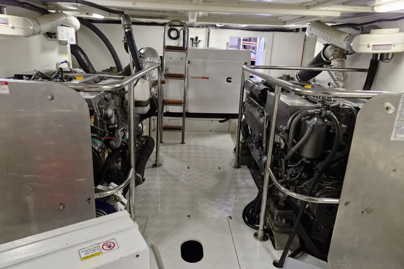 Mazu Yacht Photos Pics Engine room of a 2011 Adagio 58 yacht, featuring dual engines and a Cummins Onan generator.