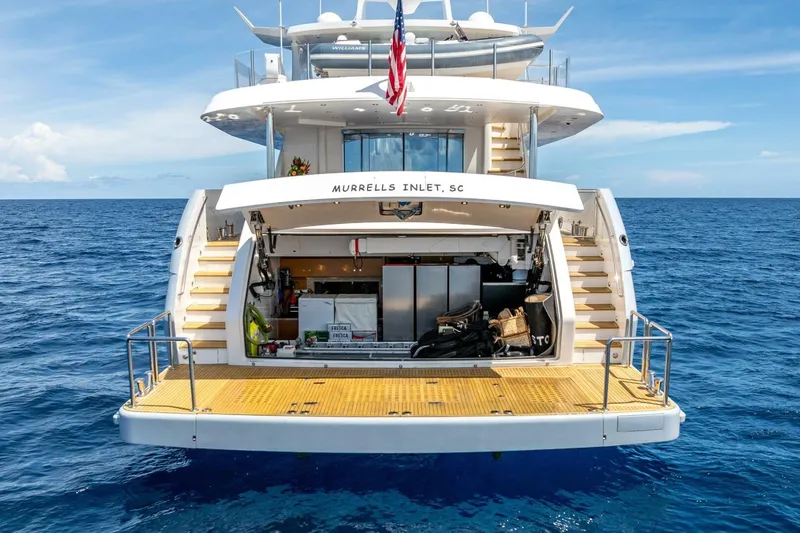 Short Story Yacht Photos Pics Luxury Horizon RP120 yacht, 2017 model, docked at sea with open storage area.