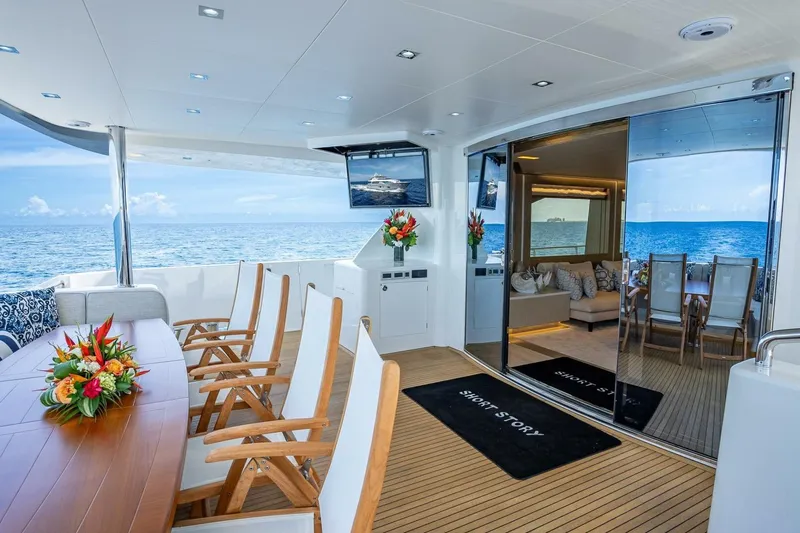 Short Story Yacht Photos Pics Luxurious Horizon RP120 yacht interior with ocean view, featuring elegant seating and floral arrangements.