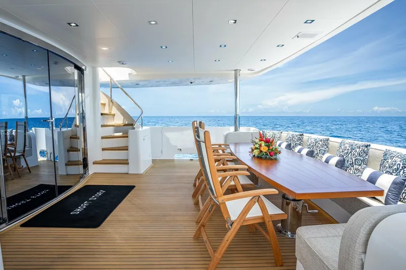 Short Story Yacht Photos Pics Luxurious Horizon RP120 yacht deck with elegant dining area, ocean view, and stylish seating, 2017 model.