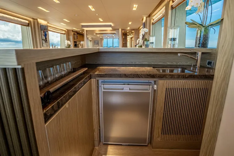 Short Story Yacht Photos Pics Luxurious yacht interior with modern kitchen, featuring wood finishes and large windows. Horizon RP120, 2017.