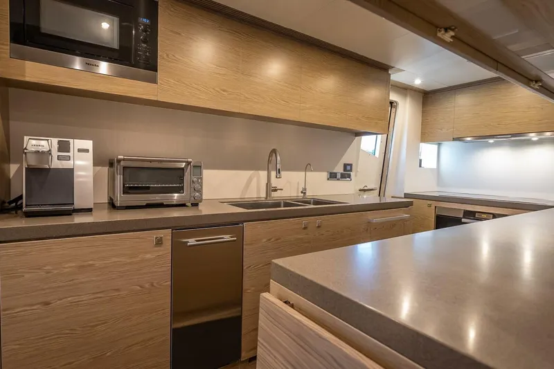 Short Story Yacht Photos Pics Modern kitchen in 2017 Horizon RP120 yacht with appliances and sleek wooden cabinetry.