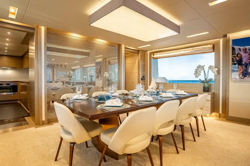 Short Story Yacht Photos Pics Luxurious dining area on 2017 Horizon RP120 yacht, featuring elegant table setting and ocean view.