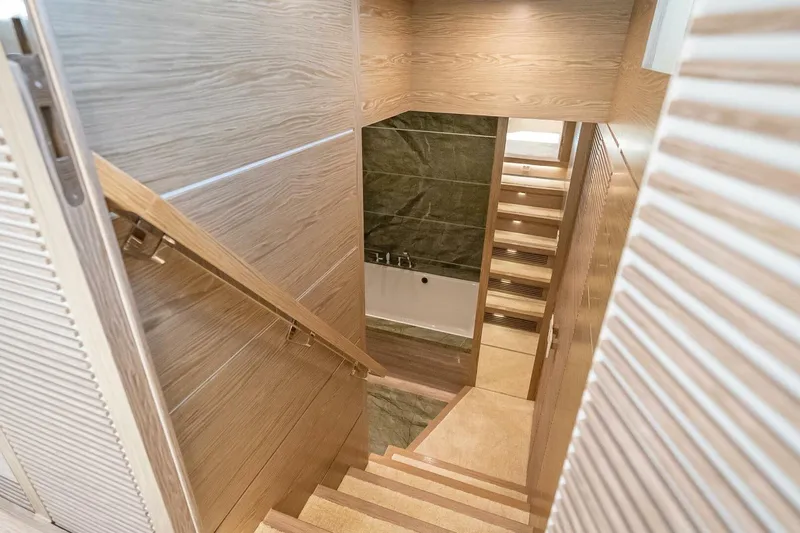 Short Story Yacht Photos Pics Wooden staircase leading to a modern bathroom in a 2017 Horizon RP120 yacht.