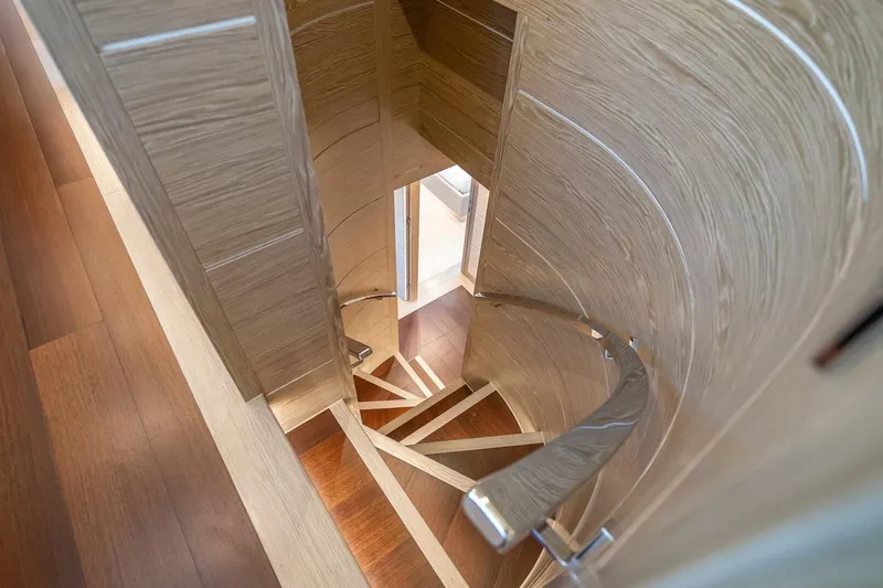 Short Story Yacht Photos Pics Spiral staircase with wooden finish inside Horizon RP120 yacht, 2017 model.