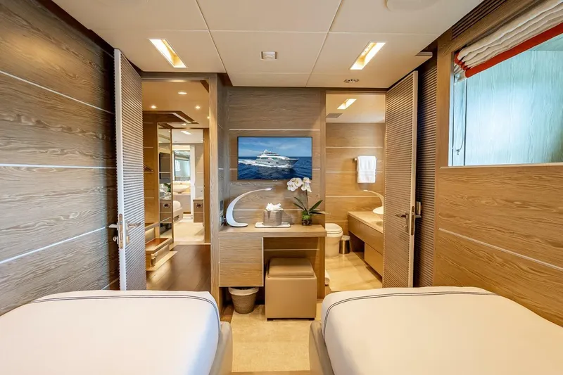 Short Story Yacht Photos Pics Luxurious yacht interior with wooden decor, featuring twin beds and elegant furnishings, Horizon RP120, 2017.
