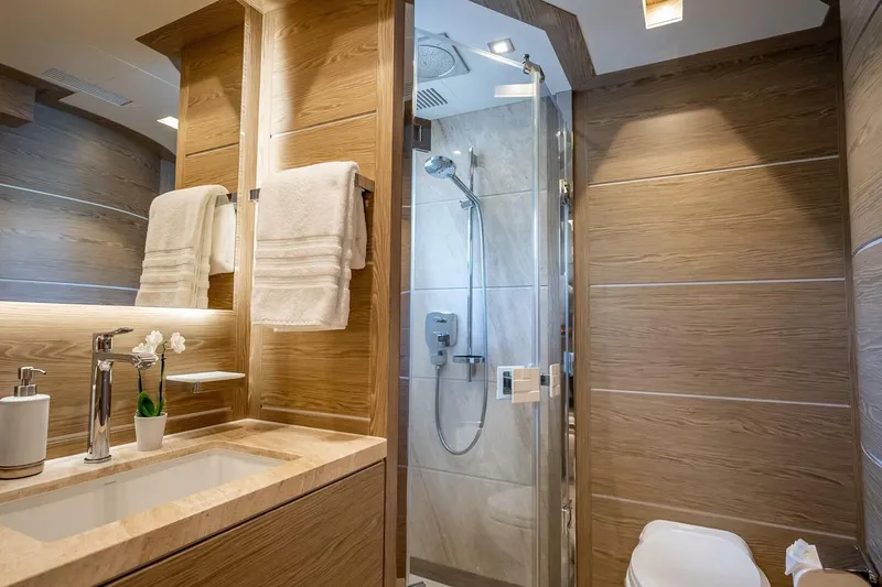 Short Story Yacht Photos Pics Luxurious yacht bathroom with wood accents, modern fixtures, and glass shower in Horizon RP120, 2017.