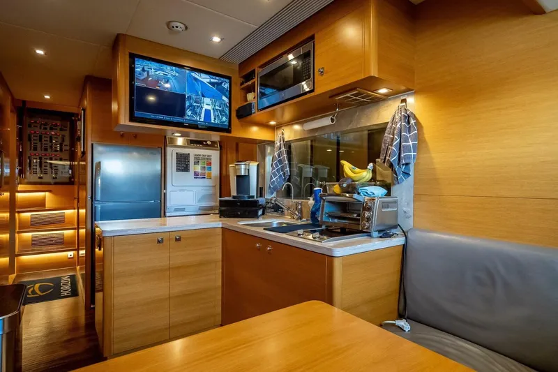 Short Story Yacht Photos Pics Luxurious kitchen interior of 2017 Horizon RP120 yacht with modern appliances and wood finish.