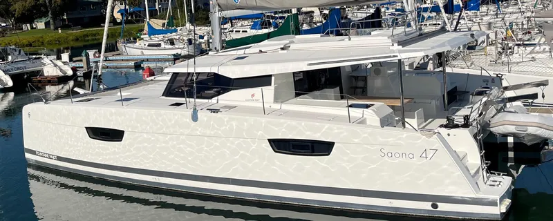 Bright Side Yacht Photos Pics 2019 Fountaine Pajot Saona 47 catamaran docked in a marina.