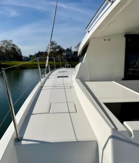 Bright Side Yacht Photos Pics 2019 Fountaine Pajot Saona 47 catamaran deck with clear sky and waterfront view.