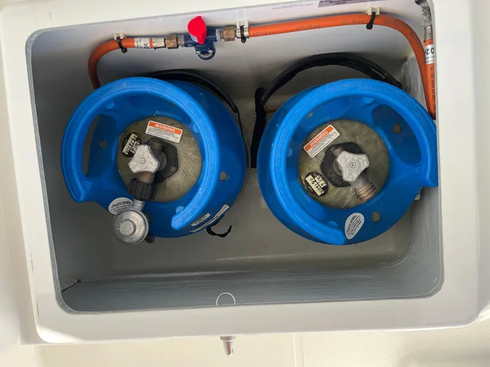 Bright Side Yacht Photos Pics Two blue gas cylinders in a compartment of a 2019 Fountaine Pajot Saona 47.