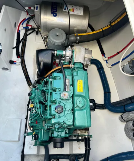 Bright Side Yacht Photos Pics Engine compartment of a 2019 Fountaine Pajot Saona 47 catamaran, featuring a well-maintained engine.