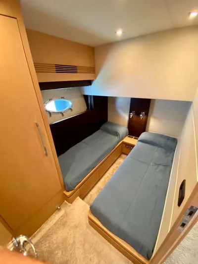  Yacht Photos Pics Interior cabin of 2008 Uniesse 68 yacht with twin beds and porthole.