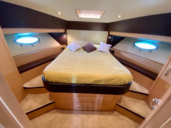  Yacht Photos Pics Luxurious cabin interior of 2008 Uniesse 68 yacht with cozy bed and porthole windows.