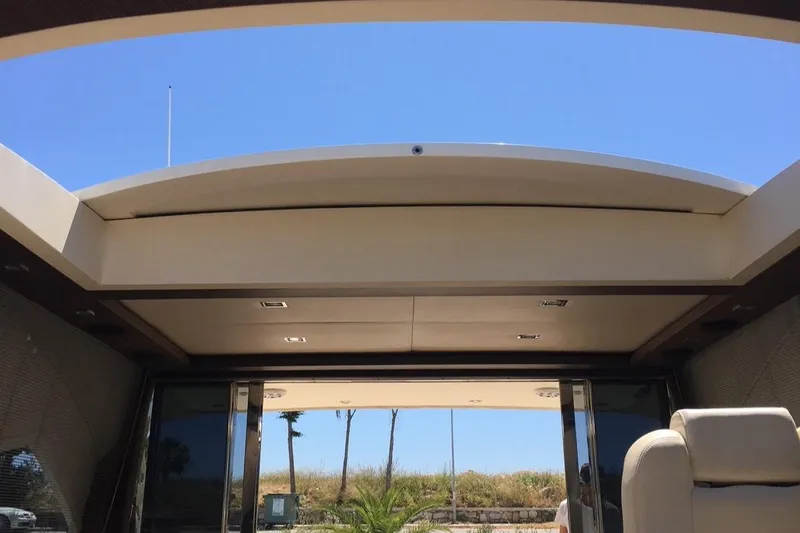  Yacht Photos Pics Interior view of a 2008 Uniesse 68 yacht with open sunroof and clear blue sky.