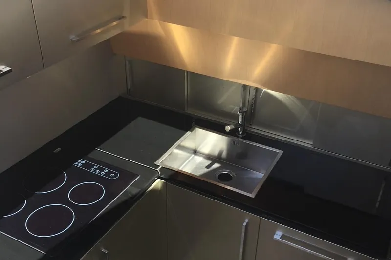  Yacht Photos Pics Modern kitchen in 2008 Uniesse 68 yacht with sleek black countertops and stainless steel sink.