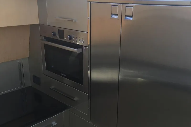 Yacht Photos Pics Modern kitchen in a 2008 Uniesse 68 yacht with stainless steel appliances.