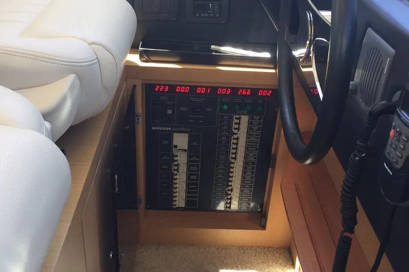  Yacht Photos Pics Control panel of a 2008 Uniesse 68 yacht, featuring digital displays and switches.