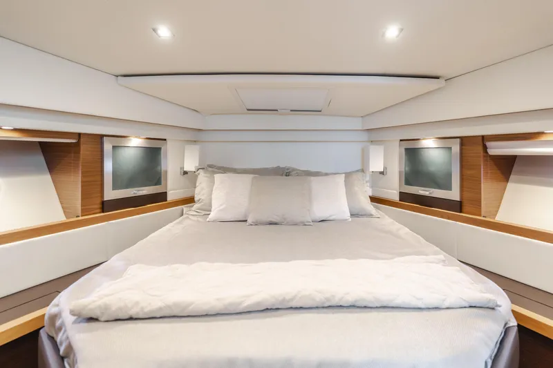 Chapter Three Yacht Photos Pics Luxurious bedroom interior of 2018 Tiara F44 yacht with modern design and cozy bedding.