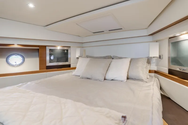 Chapter Three Yacht Photos Pics Luxurious bedroom interior of 2018 Tiara F44 yacht with elegant bedding and modern design.