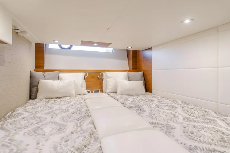 Chapter Three Yacht Photos Pics Luxurious cabin interior of 2018 Tiara F44 yacht with elegant bedding and modern lighting.