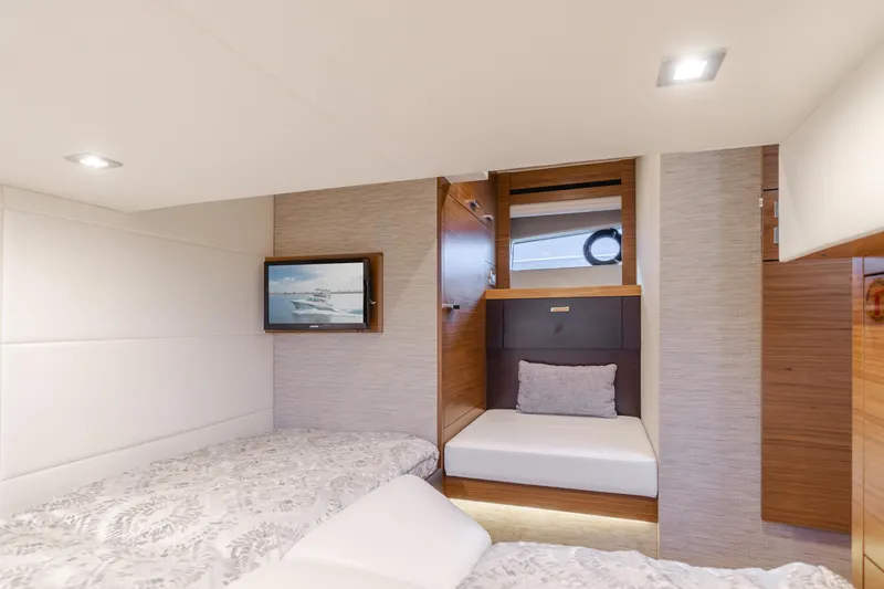 Chapter Three Yacht Photos Pics Luxurious 2018 Tiara F44 yacht cabin with modern decor and cozy bedding.
